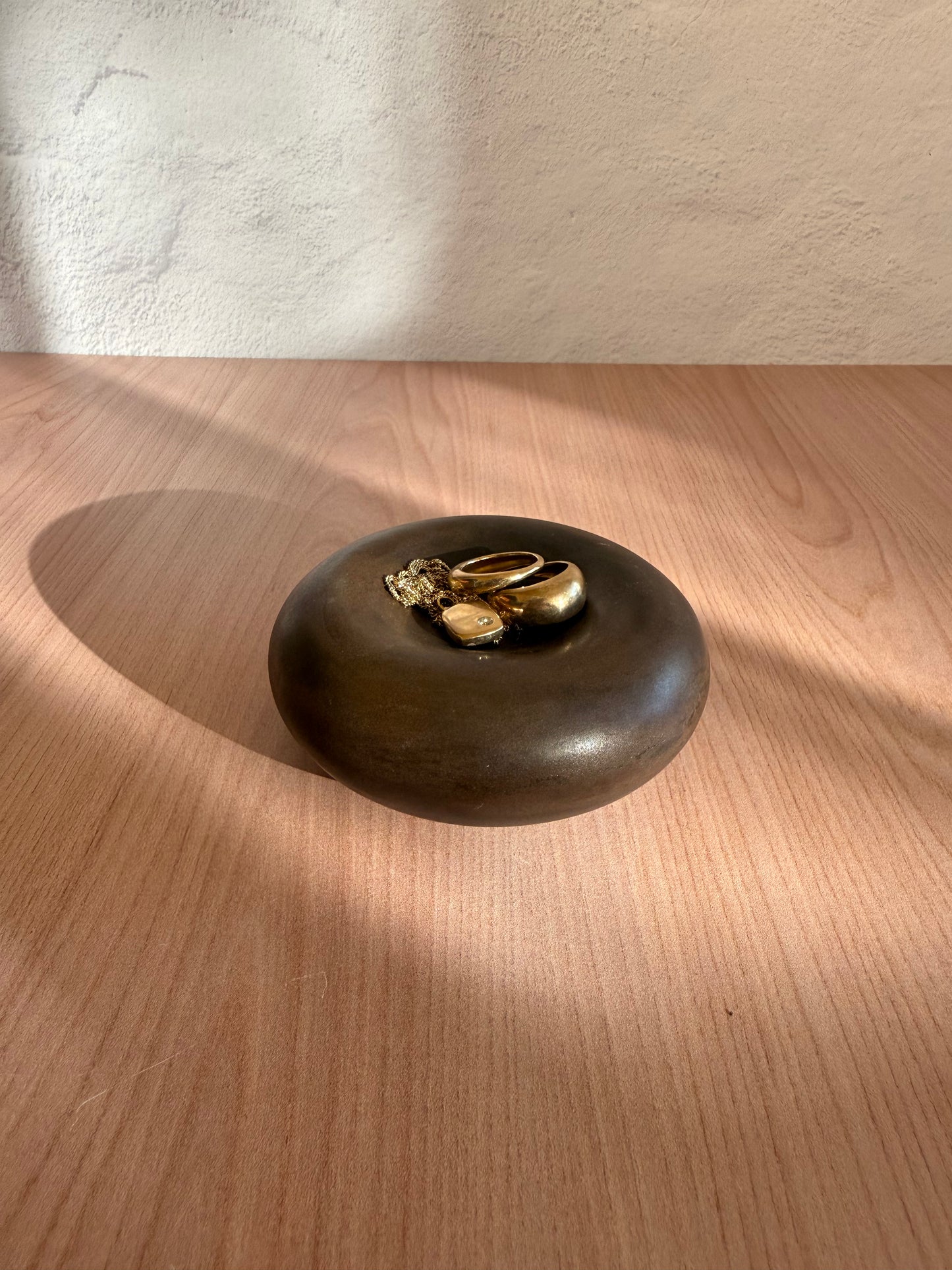 Round handmade ceramic catch-all dish with glossy bronze glaze