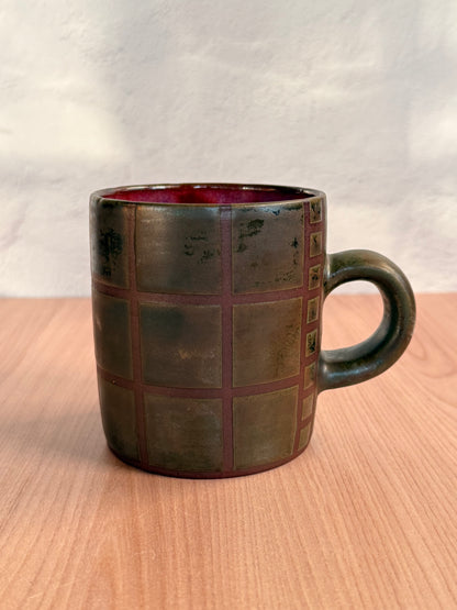 Handmade ceramic mug with carved grid texture and olive bronze glaze