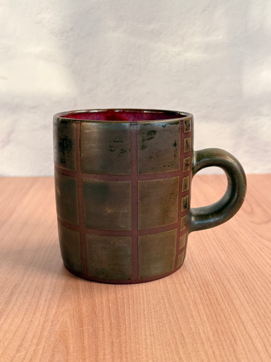 Handmade ceramic mug with carved grid texture and olive bronze glaze