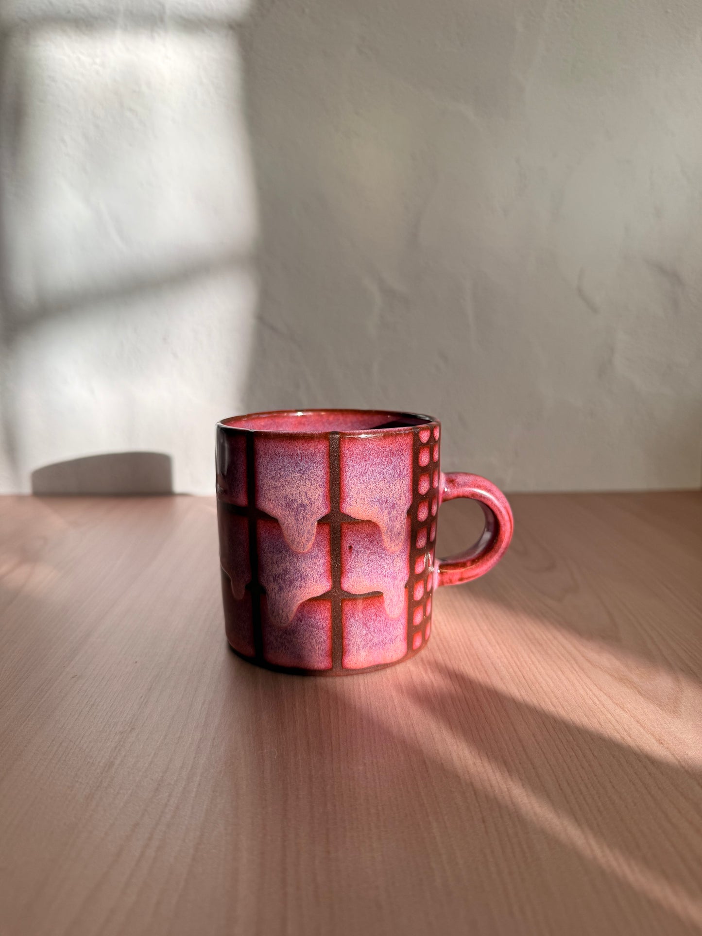 Handmade ceramic mug with dusty mauve crackle glaze and grid texture