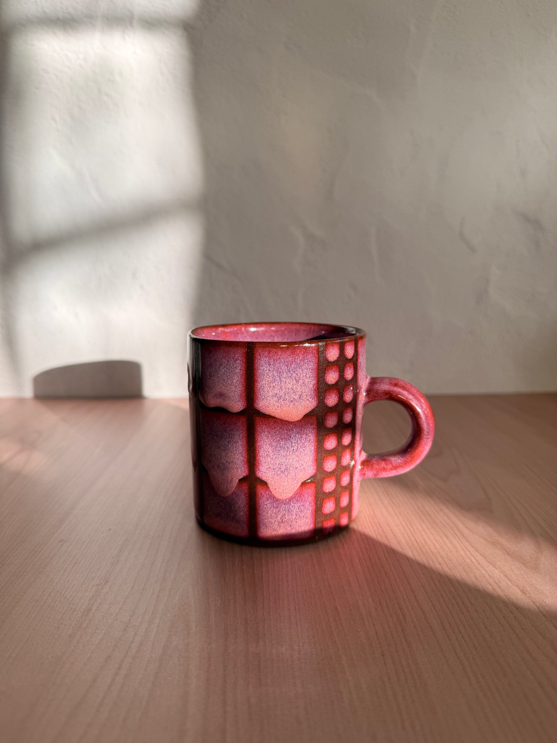 Handmade ceramic mug with coral crackle glaze and grid texture