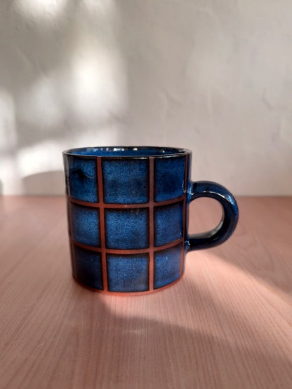 Handmade ceramic mug with indigo blue crackle glaze and grid texture