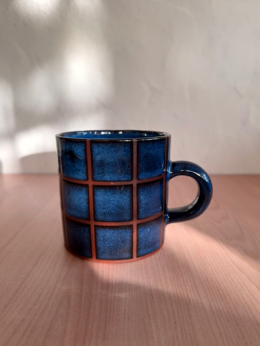 Handmade ceramic mug with indigo blue crackle glaze and grid texture