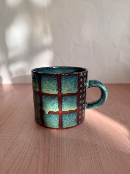 Handmade ceramic mug with seafoam green crackle glaze and grid texture