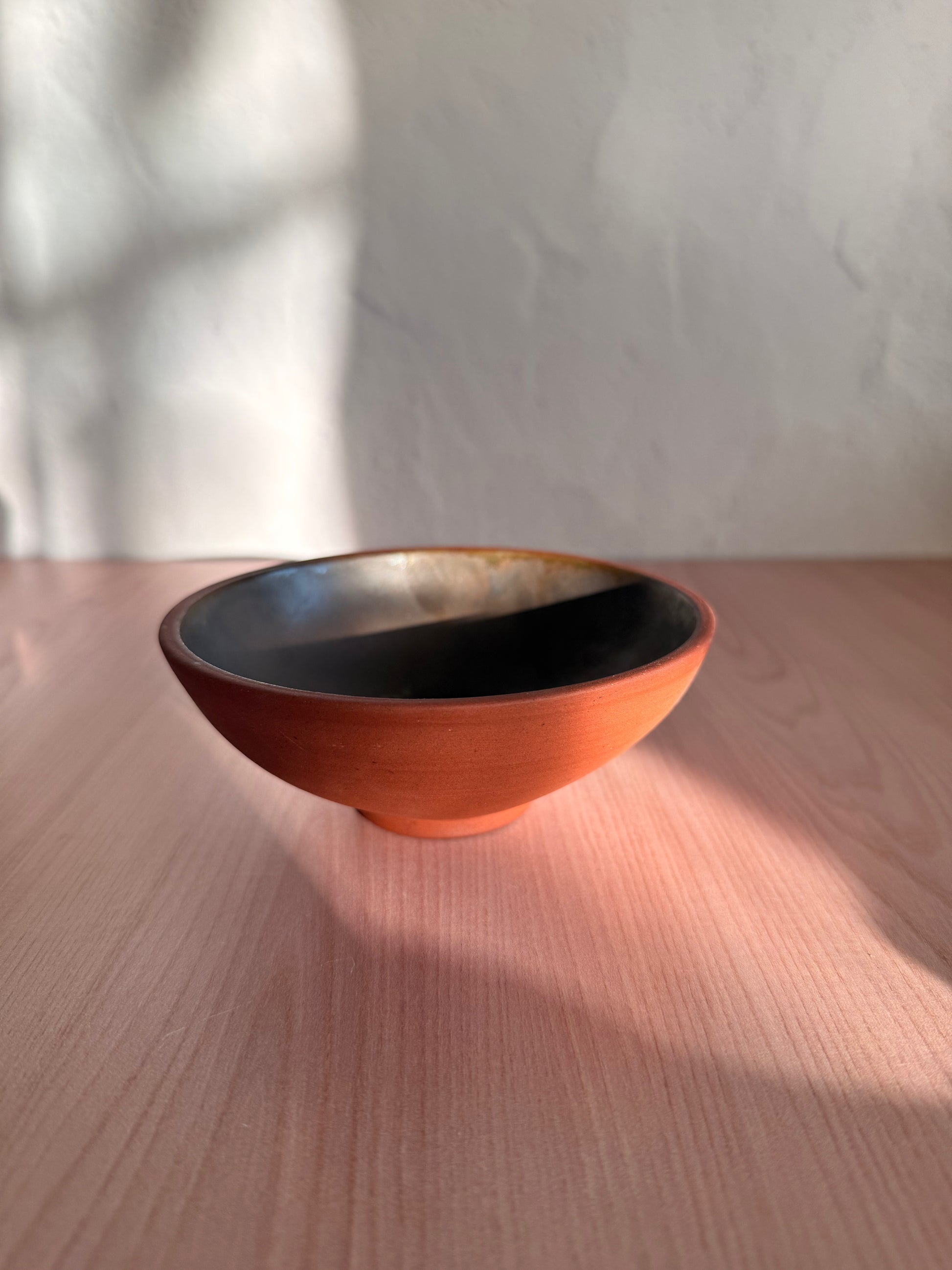 Handmade ceramic bowl with raw exterior and satin brown interior glaze