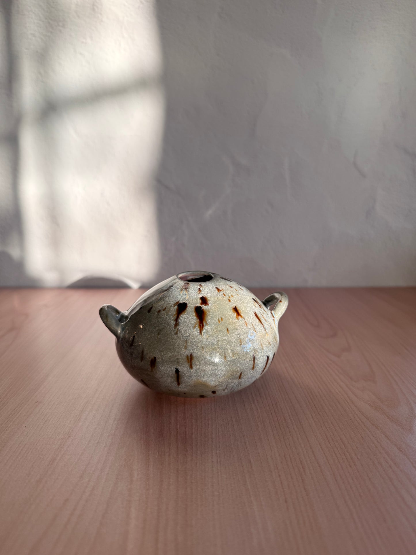 Small handmade ceramic bud vase with handles and speckled cream glaze
