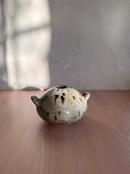 Small handmade ceramic bud vase with handles and speckled cream glaze