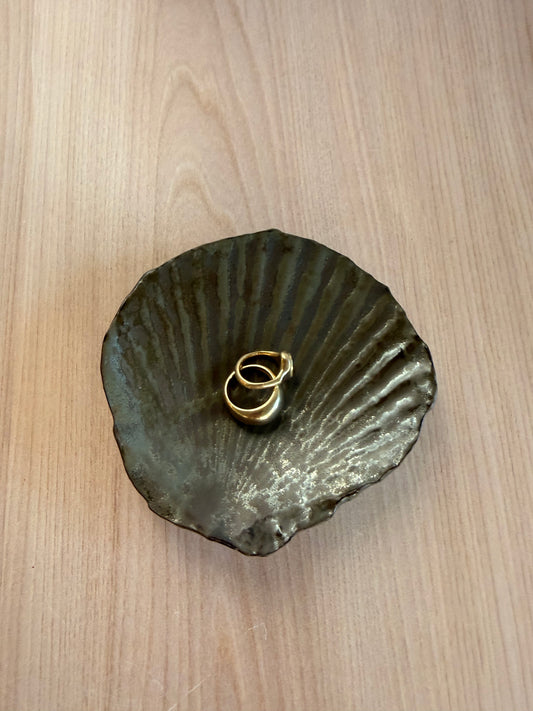 Handmade ceramic scallop shell dish in a deep green glaze