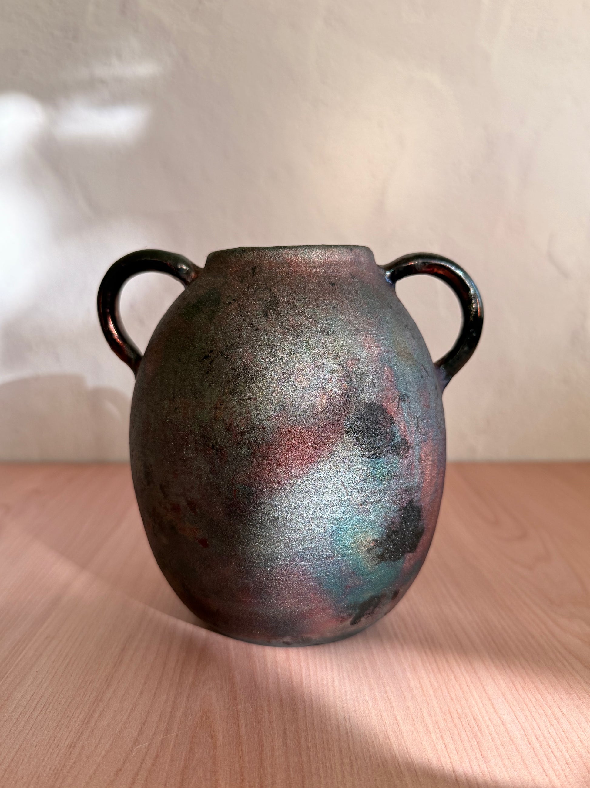 Handmade raku-fired ceramic vase with mottled copper and blue finish
