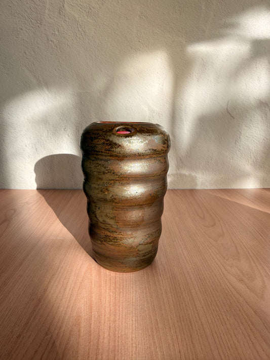 Handmade ceramic travel mug with ribbed texture and bronze glaze